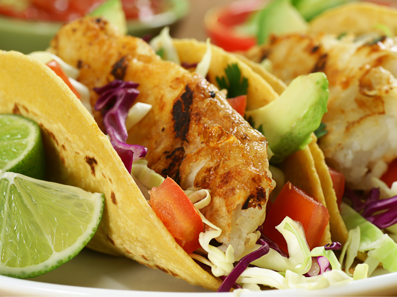 fish tacos with slices of lime