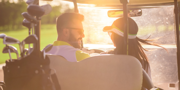 couple riding in golf cart, bolivar peninsula golf course