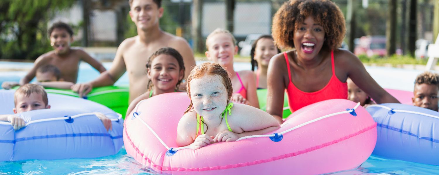 family at water park with inner tubes on lazy river