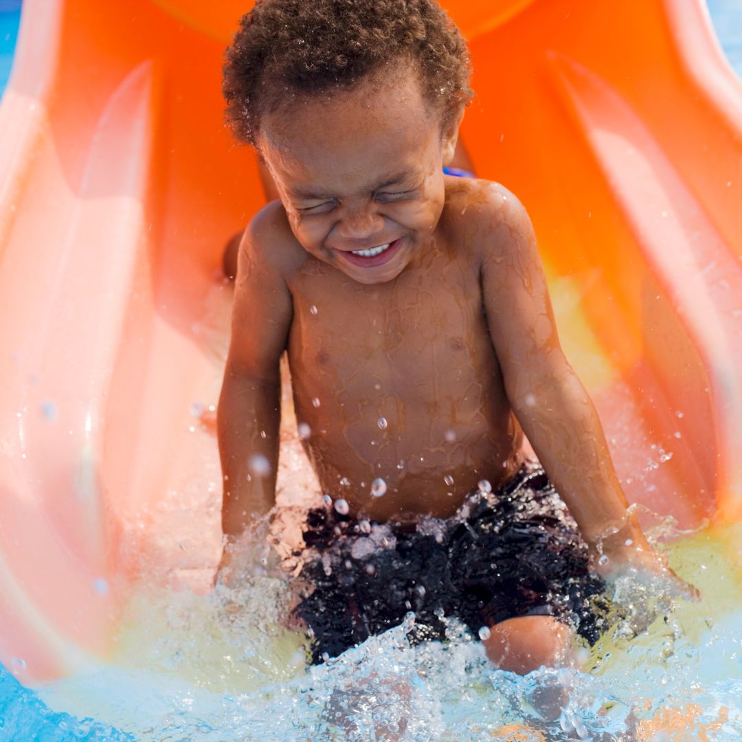 little boy on water slide