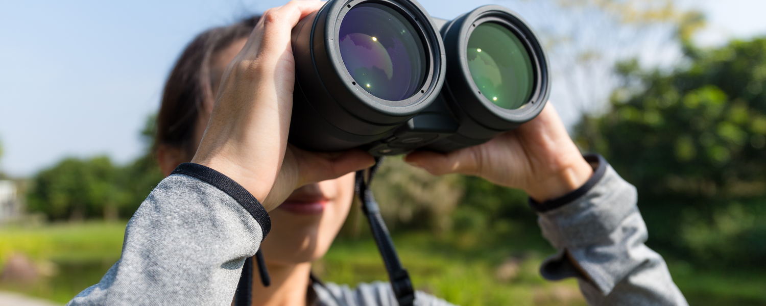 person looking through binoculars