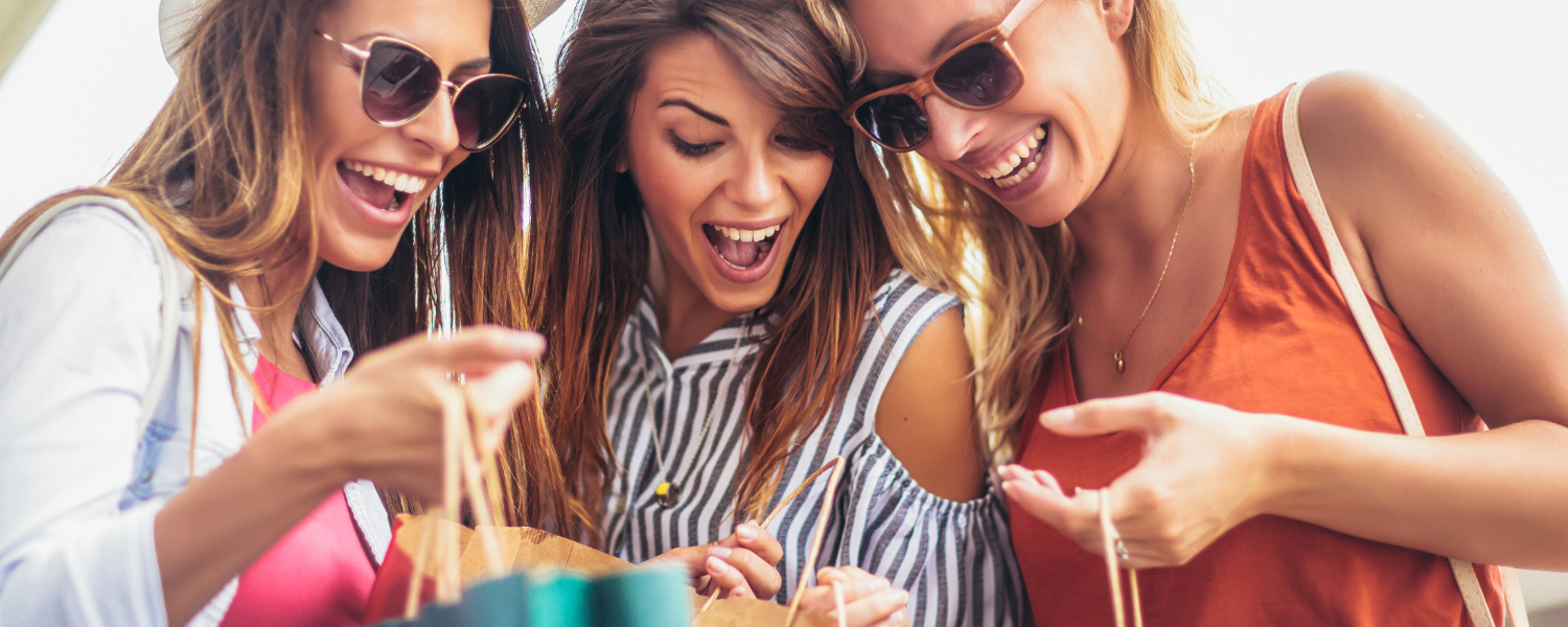 three woman with shopping bags