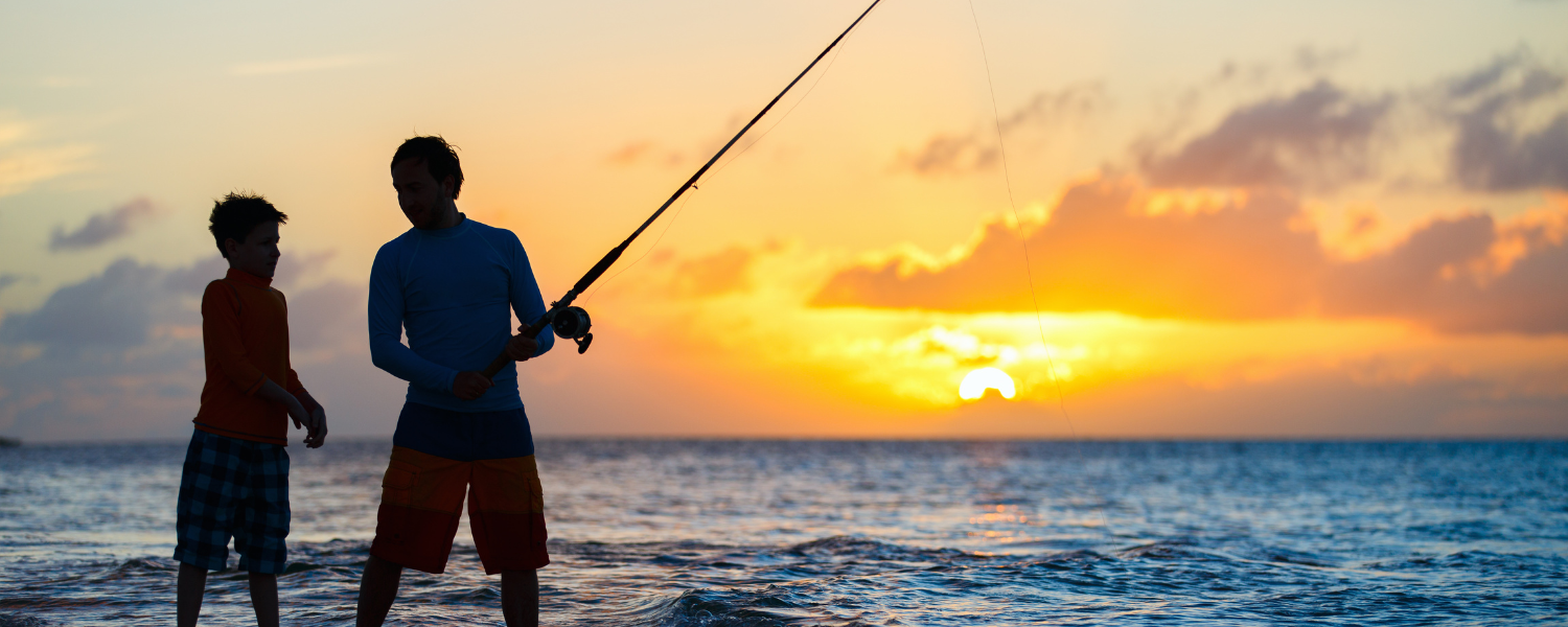 two people on beach surf fishing